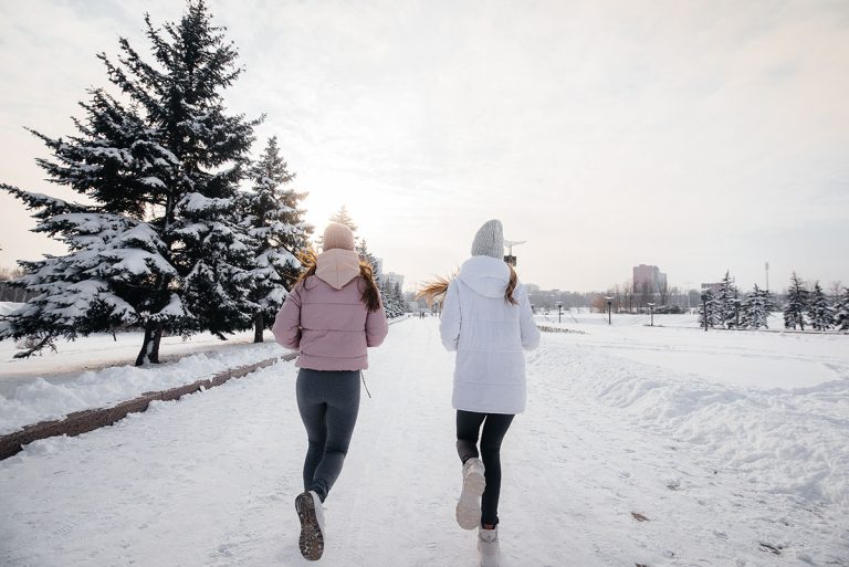 Women jogging on a snow covered path